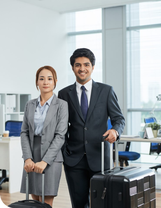 Businessman and woman in suits discussing plans in an office, with suitcases, symbolizing immigration consultancy services.