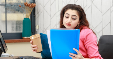 A focused woman sits at her desk with a folder, representing immigration consultancy services in Chennai.